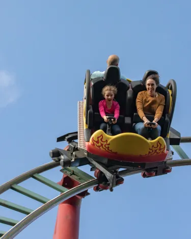 Family having fun while riding the Dragon's Fury at Chessington World of Adventure Resort.