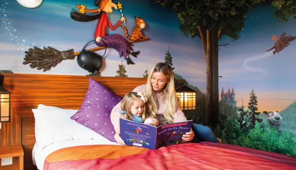 Family reading in a Room on the Broom hotel room in the Chessington Safari Hotel