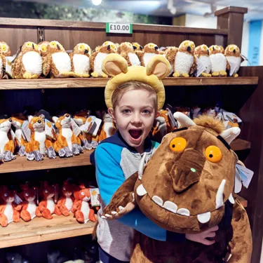 Child holding big Gruffalo toy