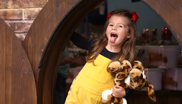 Child sticking her tongue out with toy