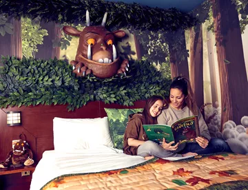 Gruffalo Hotel Room - parent reading to child on bed